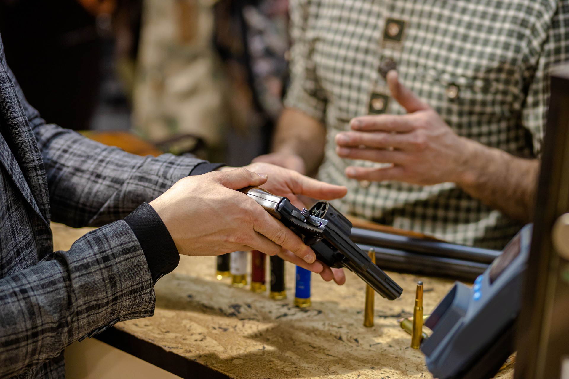 close-up photo of men using gun in store